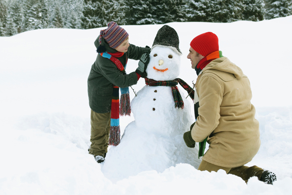 Father and son build a snowman